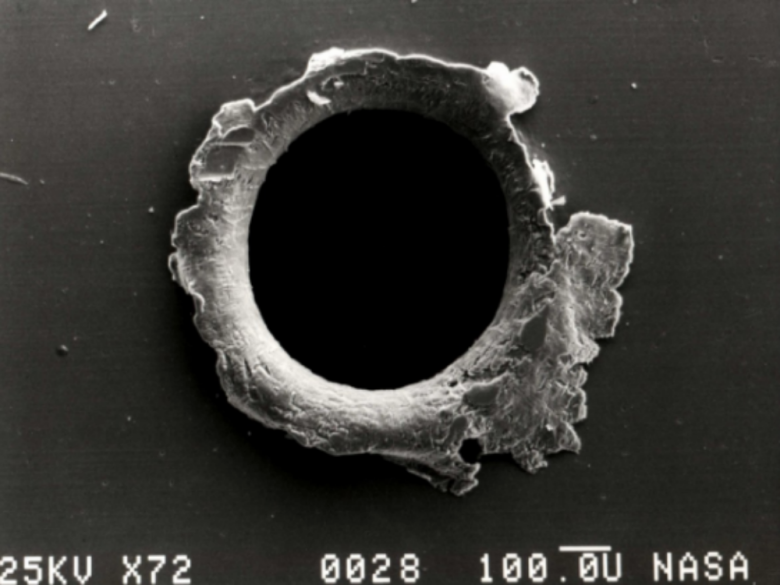 A hole in a satellite caused by space debris.