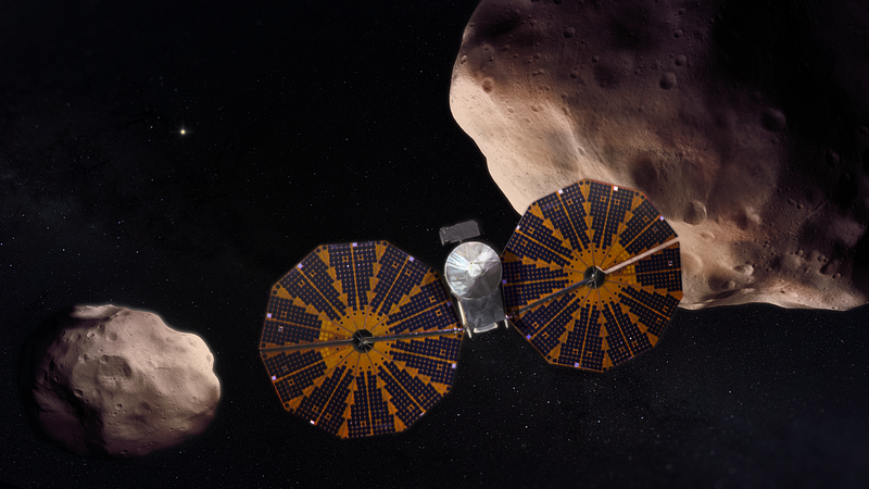 Conceptual image of Lucy spacecraft near Trojan asteroids